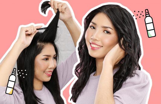 wanita asia dengan rambut panjang sedang menggunakan hairspray