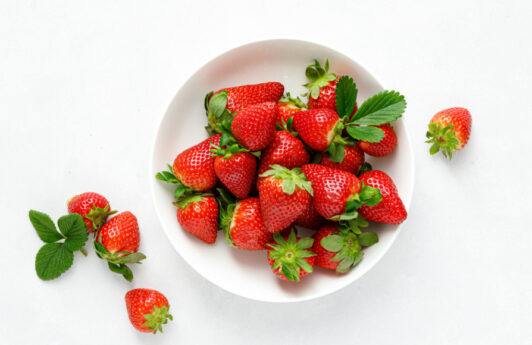 Buah Strawberry berwarna merah dalam mangkuk putih