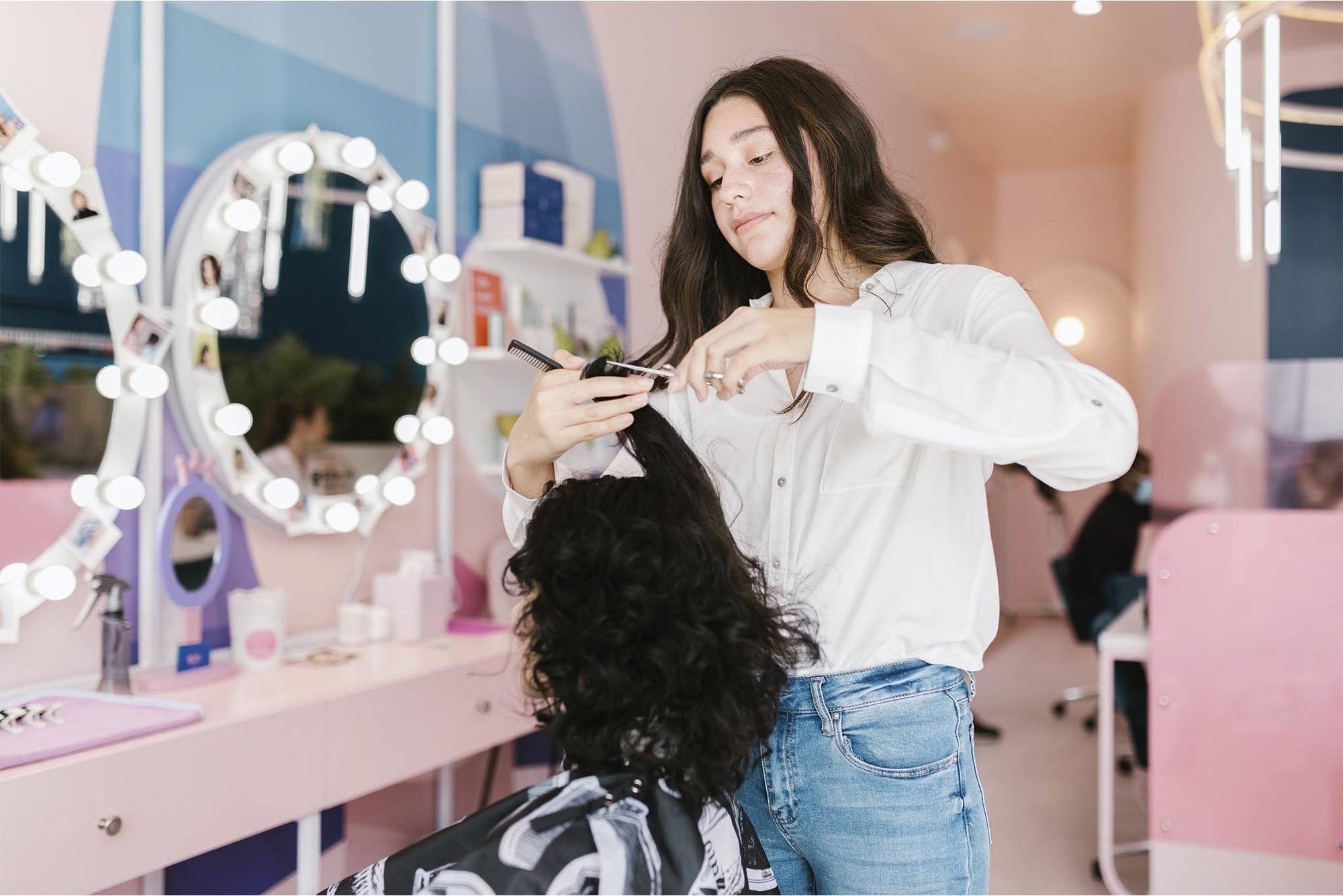 woman in hair salon getting hair ends trimmed, healthy hair