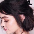 mujer de perfil con pelo corto negro con peinado semirecogido con dos moños, peinados cabello corto para fiesta