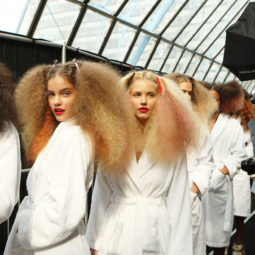 Models with frizzy hair backstage at Topshop Unique 2011.