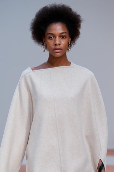 Deep conditioner for natural hair: Runway model with natural afro hair wearing a cream oversized dress on the Celine FW15 runway.