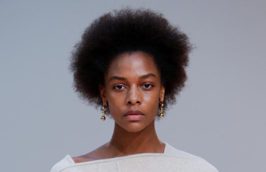 Deep conditioner for natural hair: Runway model with natural afro hair wearing a cream oversized dress on the Celine FW15 runway.