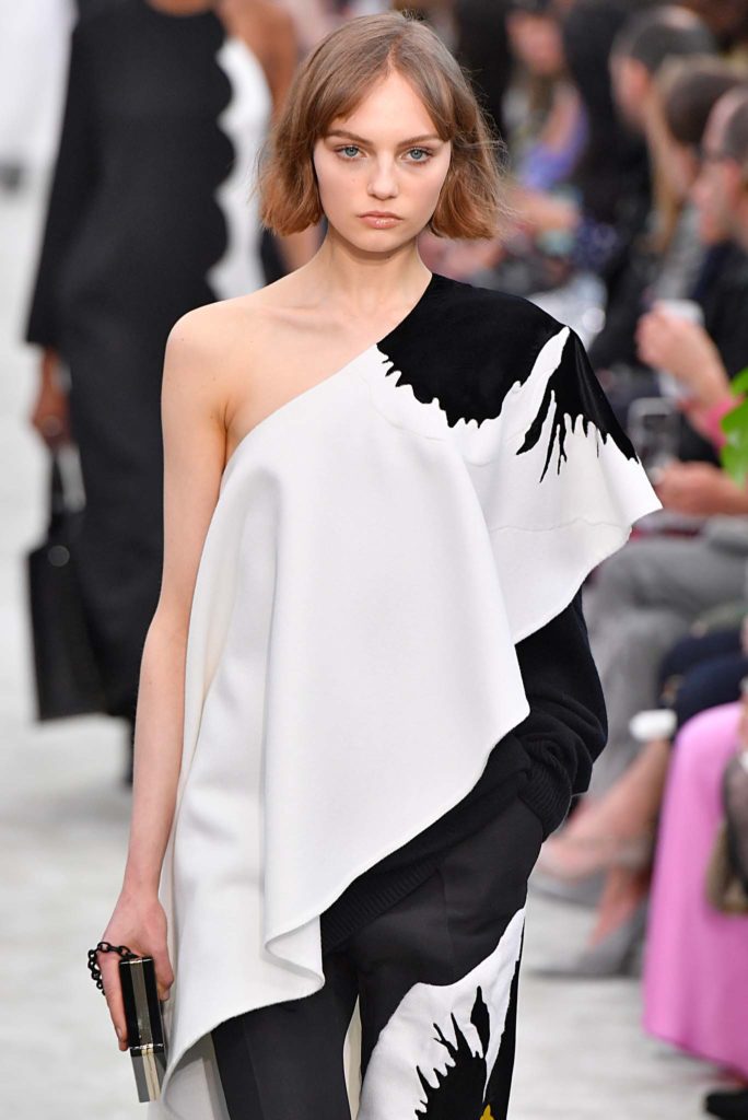 New hairstyle: Model with dark blonde bob and centre part bangs on Valentino FW18 runway wearing a one shoulder dress.