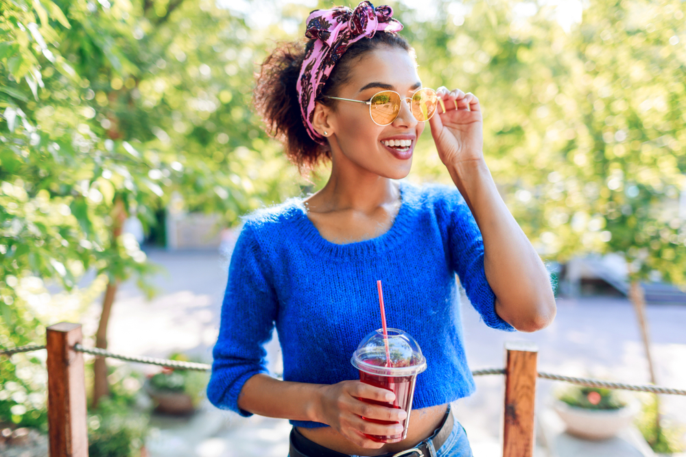 woman in blue shirt short hairstyles natural hair pink headband accessories