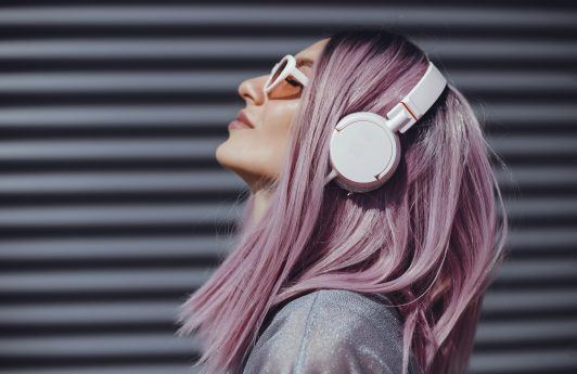 Woman with headphones light purple hair lilac hair long bob