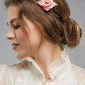 woman with low bun hairstyle flowers in hair