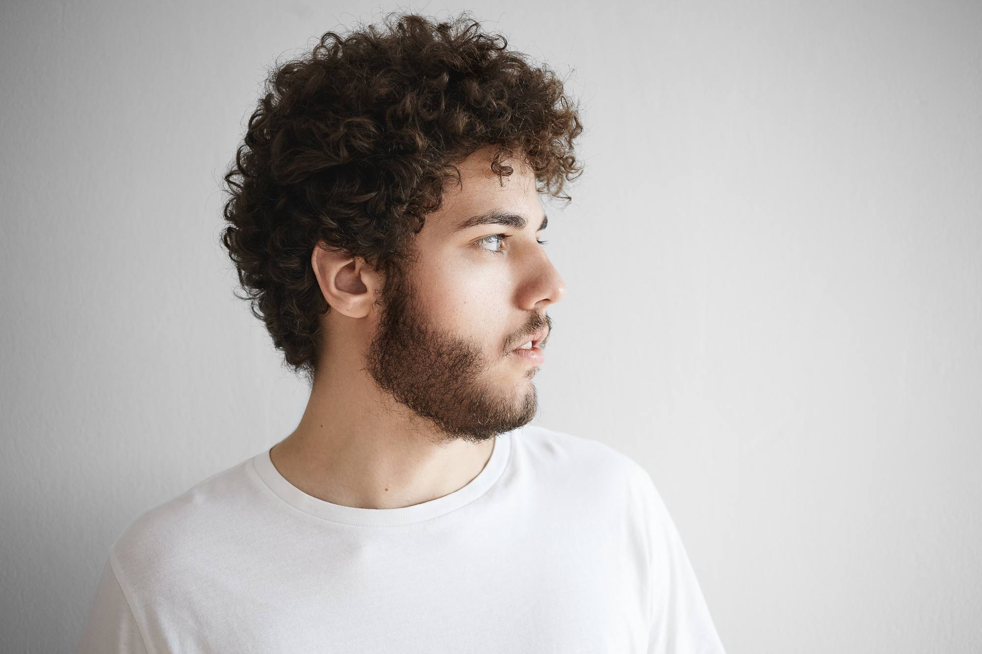 Man with short curly hair dark brown tight curls