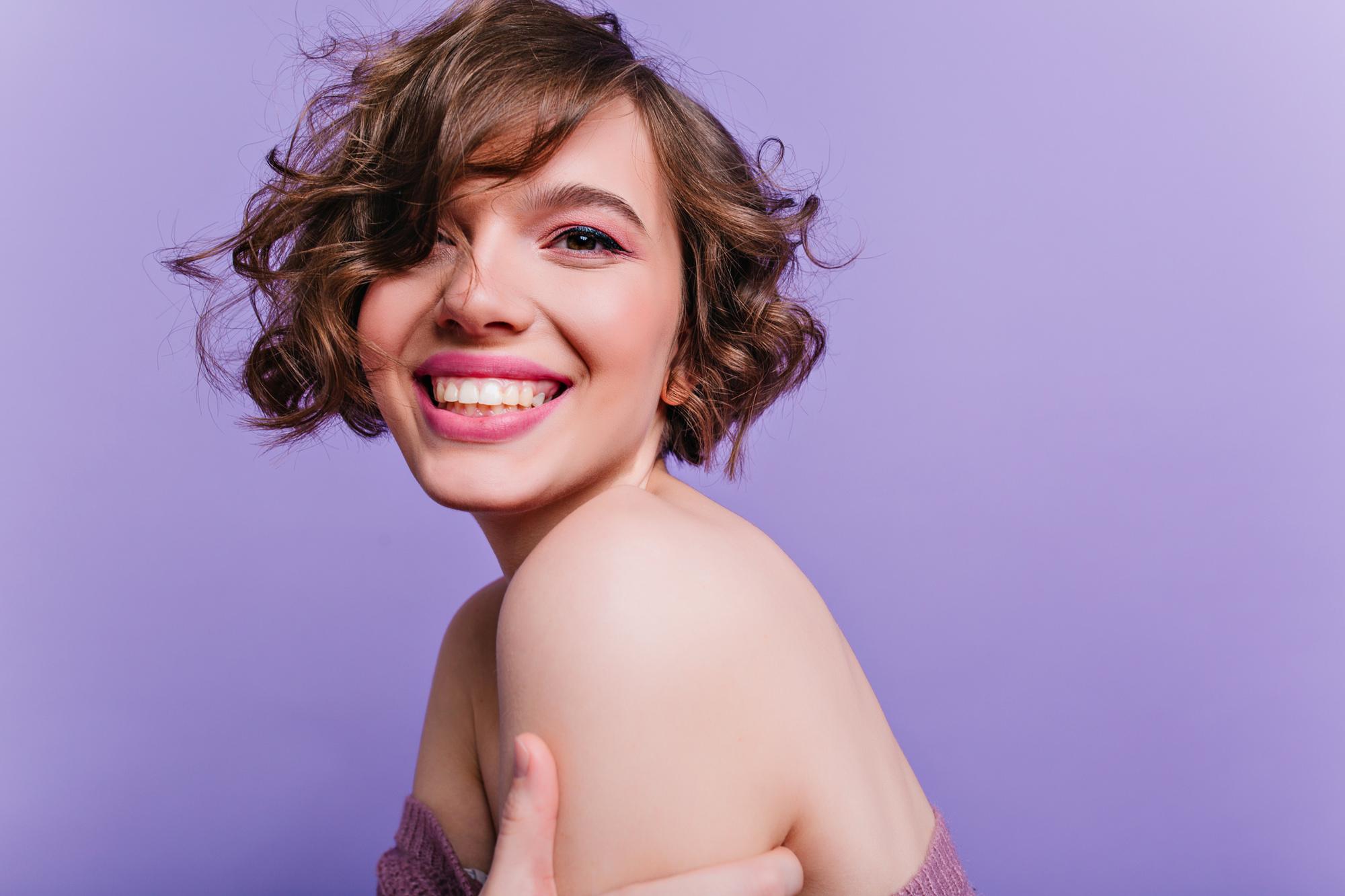 woman with short bob haircut curly messy hair
