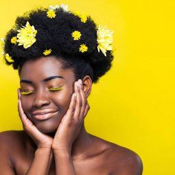 woman with large afro and yellow flower accessories
