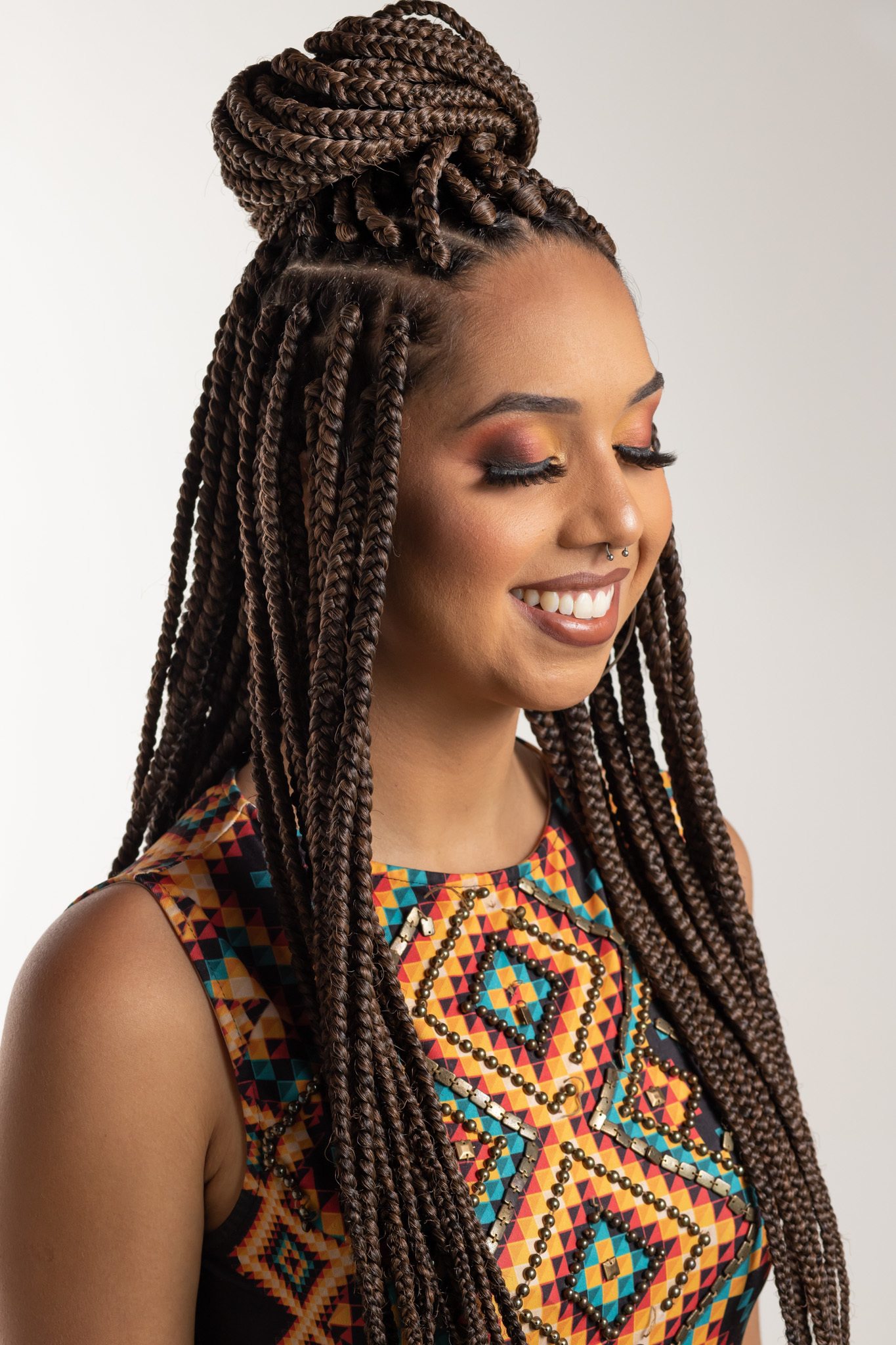 Women with long braided hair and a braided top knot