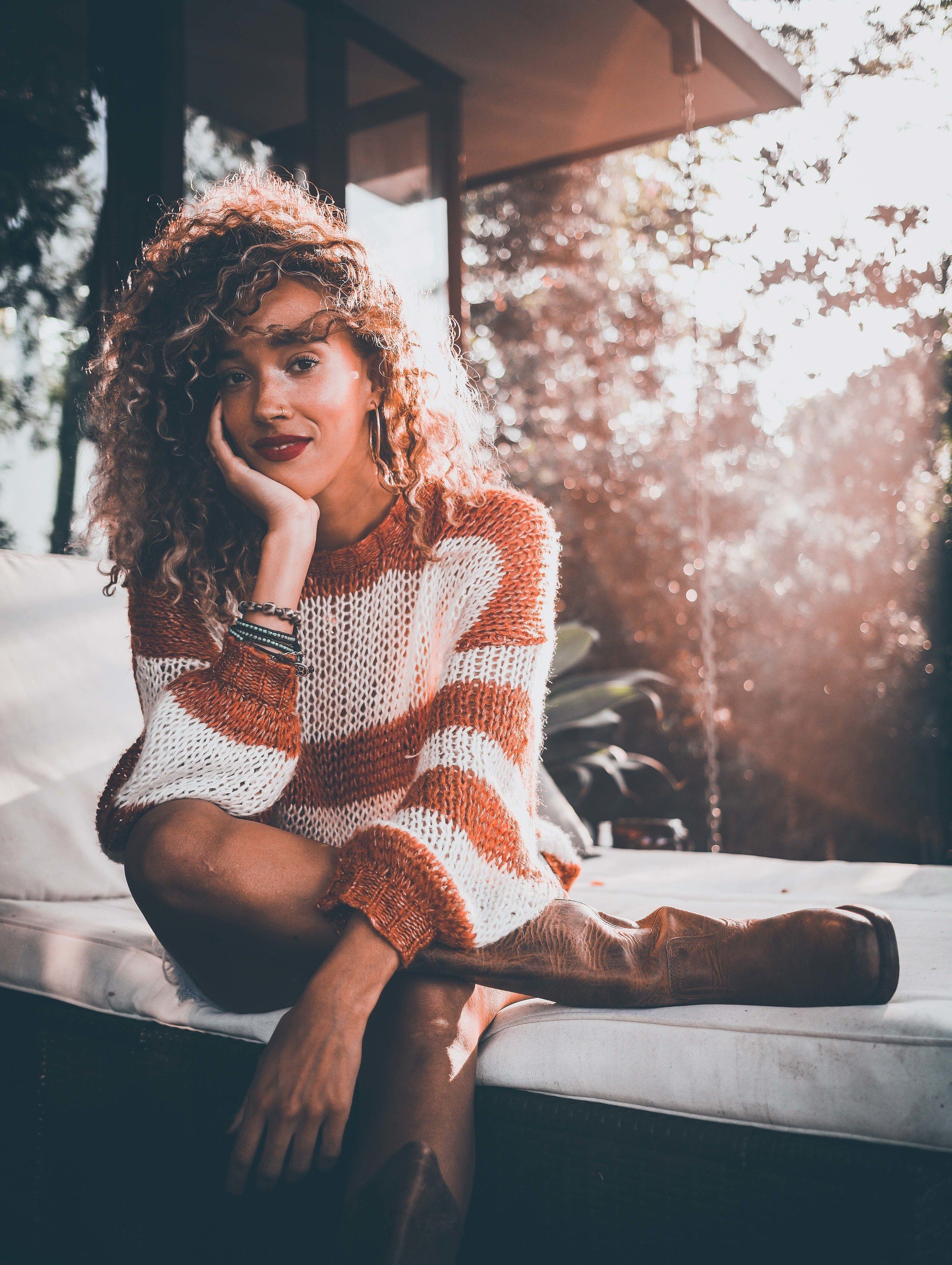 woman with curly medium length hair and mini lowlights