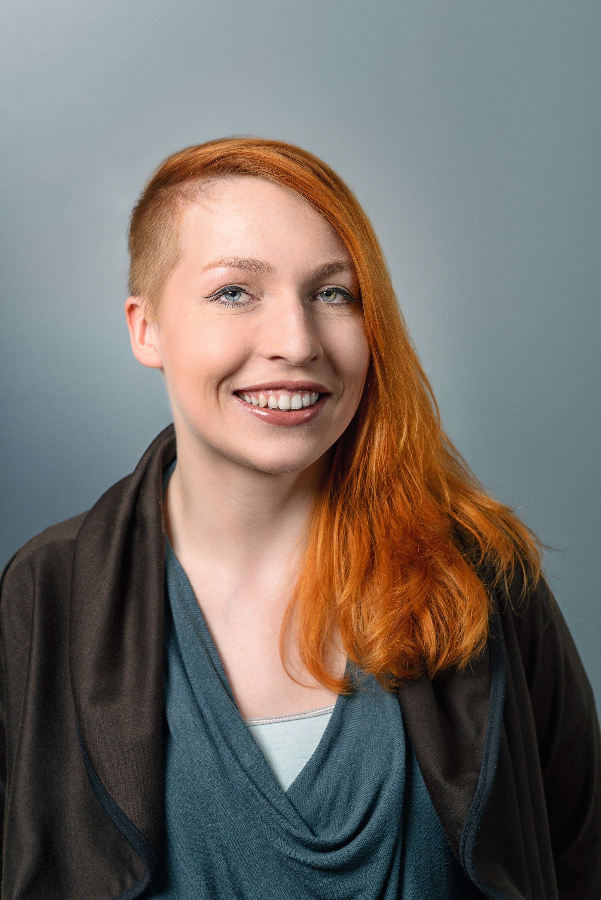 woman with bright orange ginger hair with side undercut