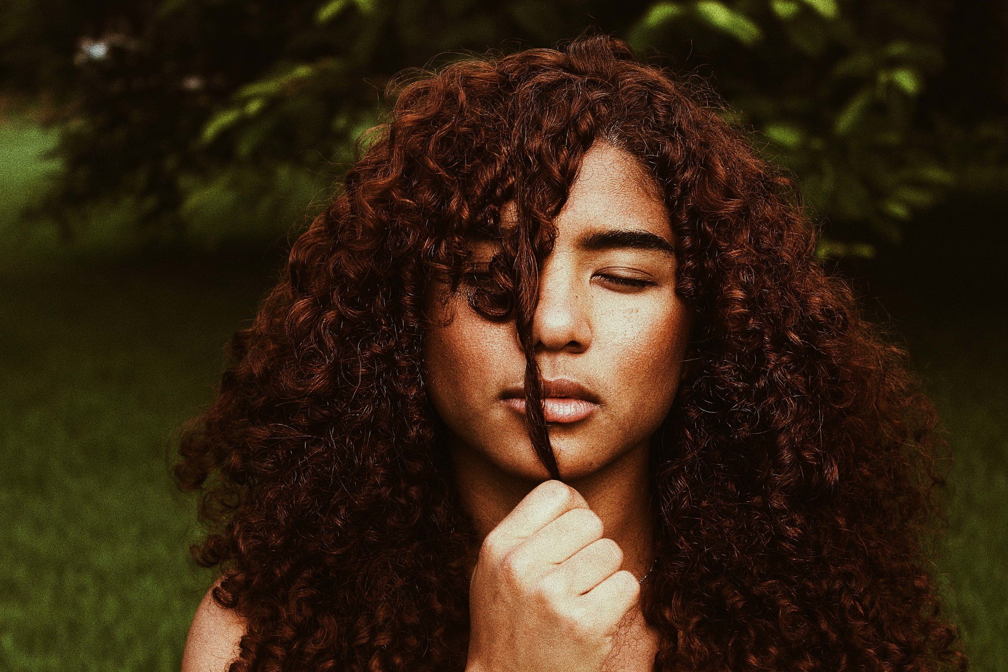 types of hair colour: woman with curly brown hair