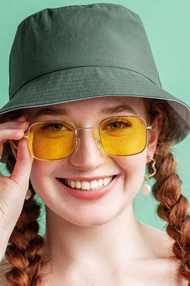 hair accessories: Happy smiling fashionable woman wearing yellow square sunglasses
