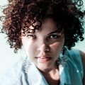 woman with a short, brown curly hairstyle