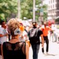 woman with flowers in her short blonde curly hair