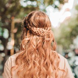 greek-inspired hairstyle: woman with long wavy strawberry blonde hair and a double braid