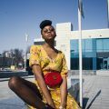 kinky curly hairstyle: woman with a high bun