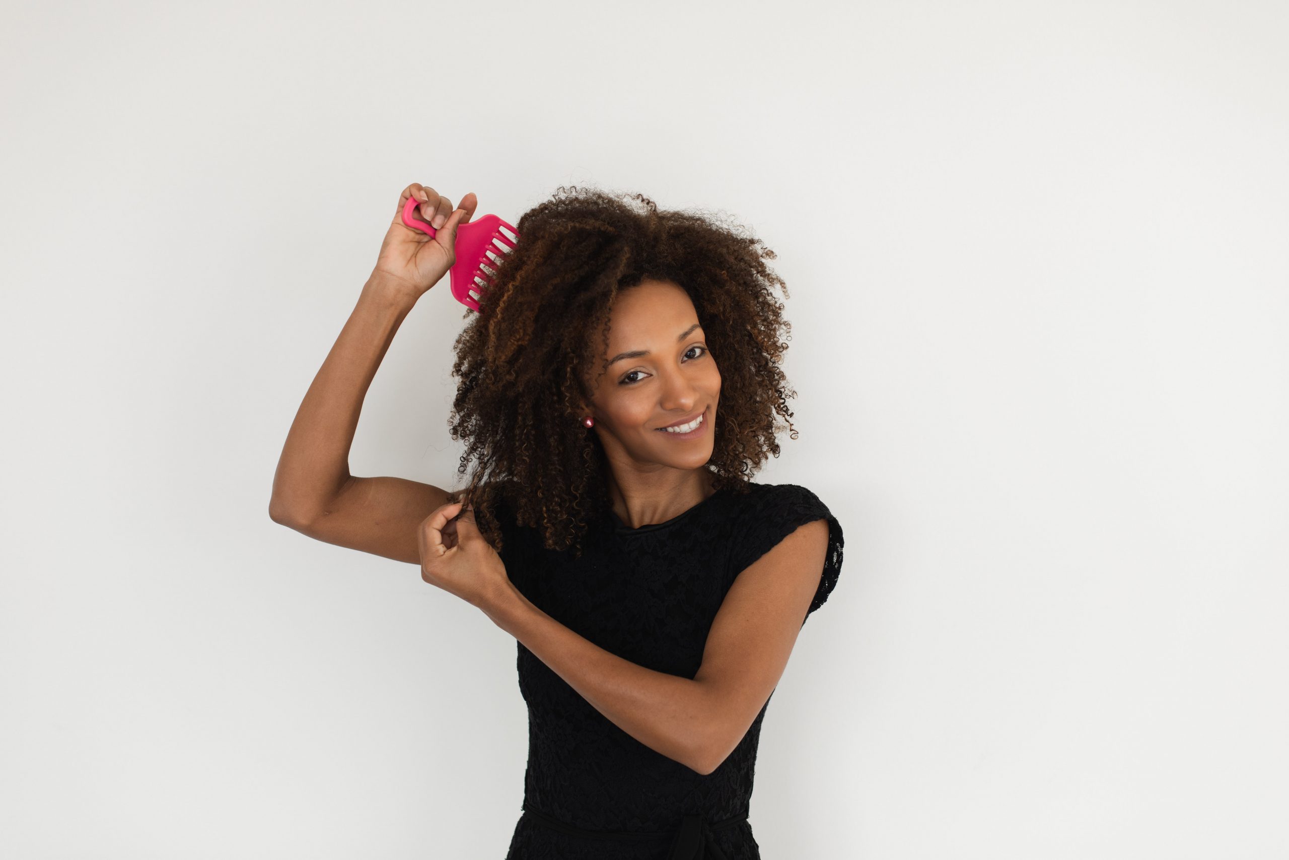 woman with curly hair and comb