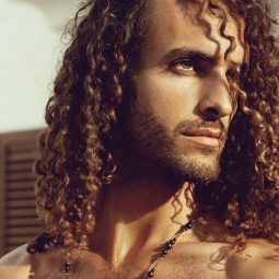 man with long defined curly hair