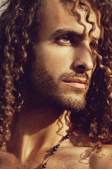 man with long defined curly hair