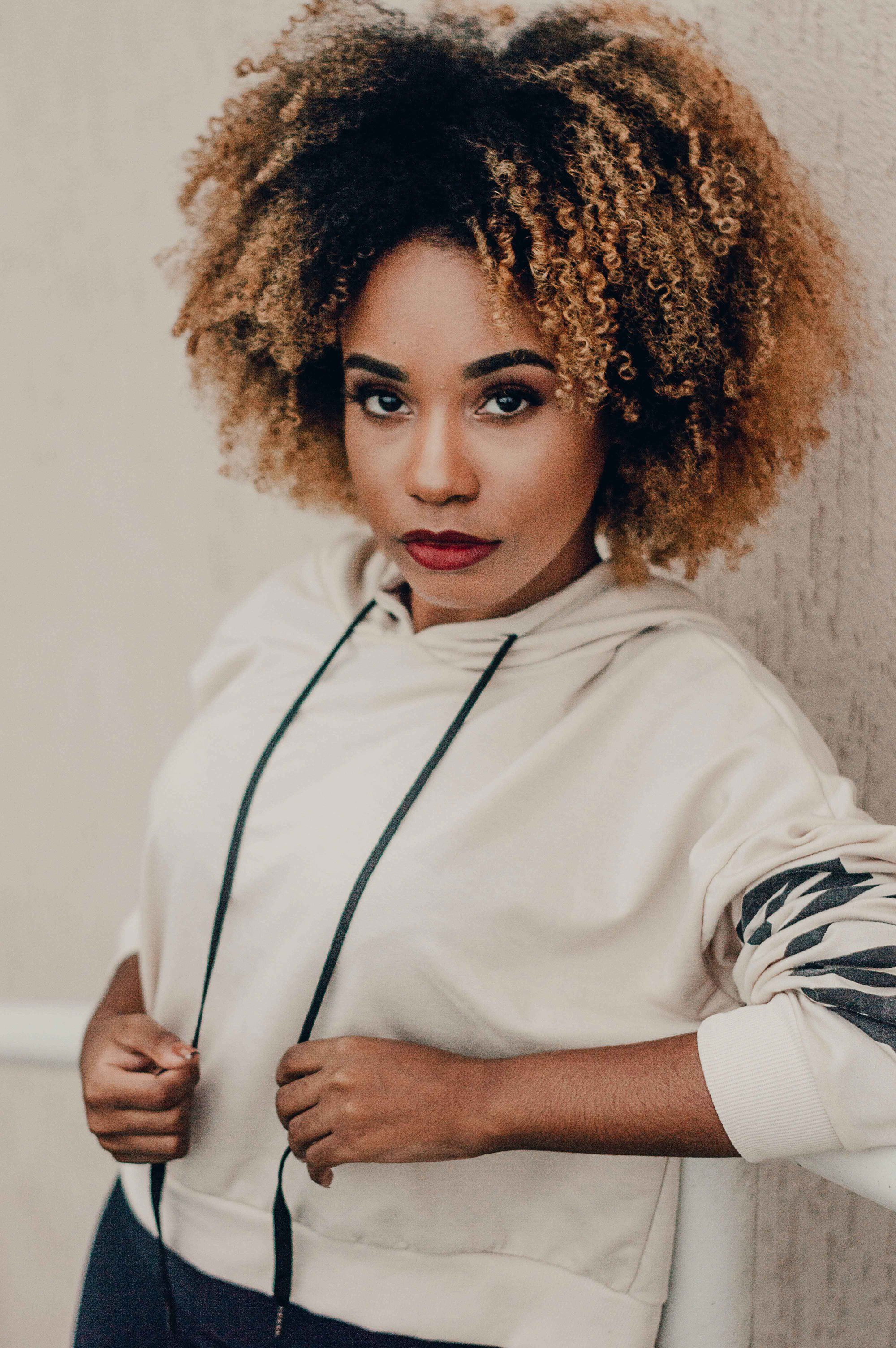 woman with curly hair and highlights