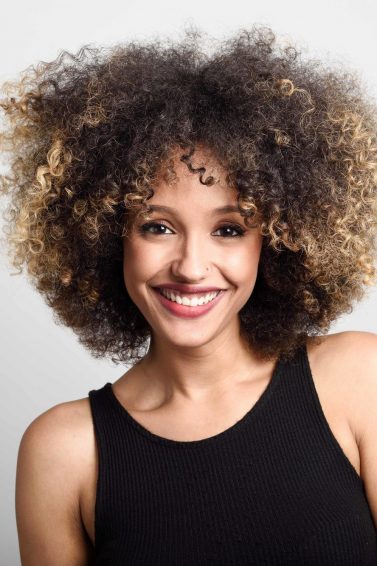 blonde with highlights: woman with curly hair