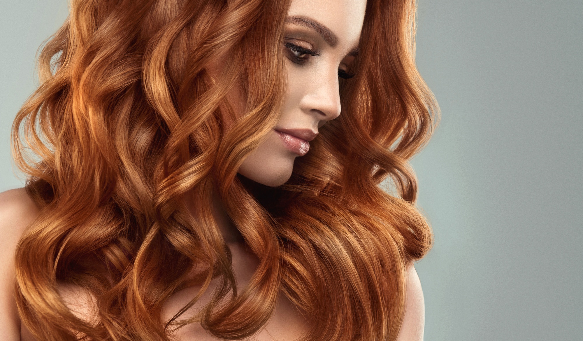 Woman with red hair and big dramatic curls