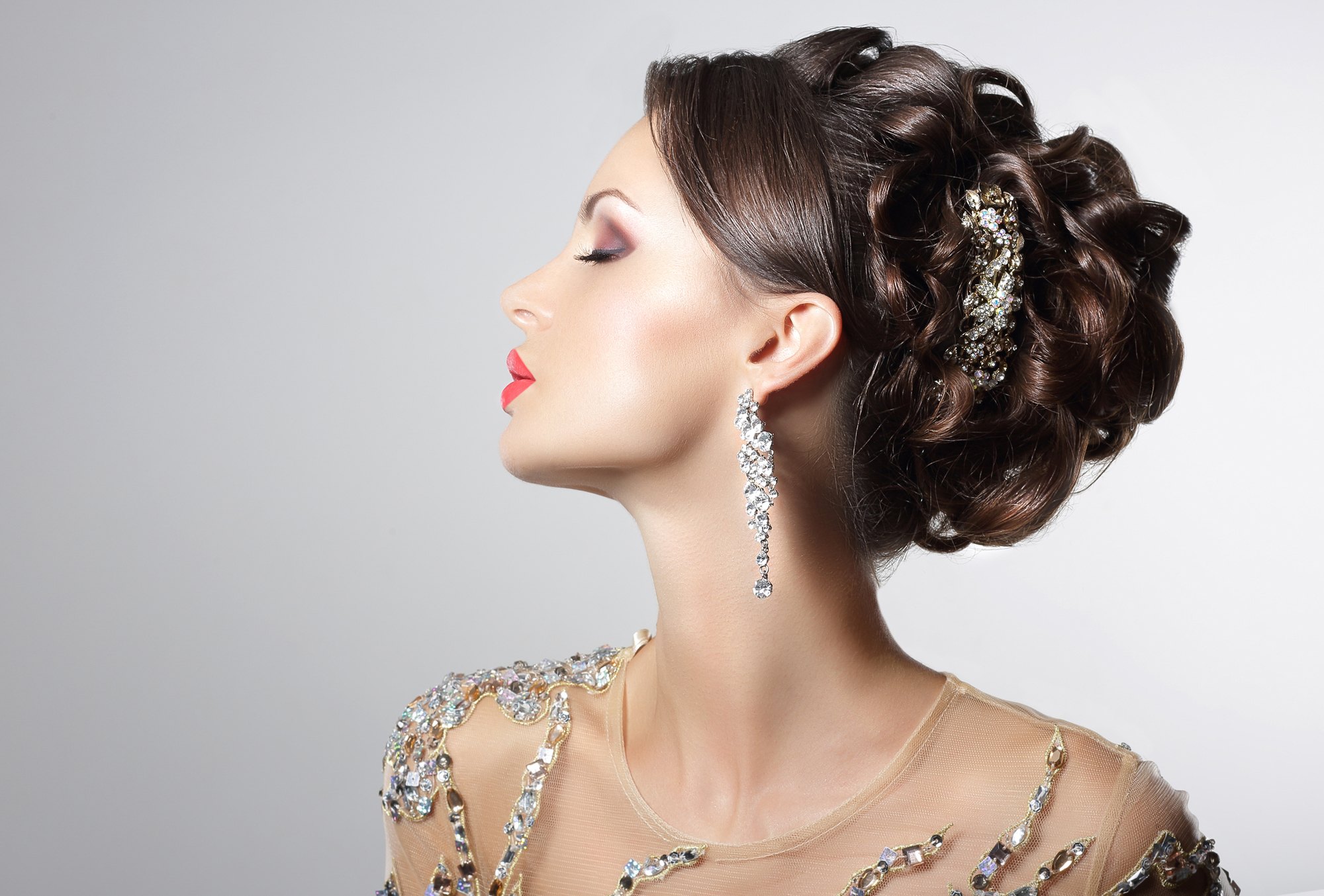 Woman wearing a NYE hairstyle with rhinestone hair accessories