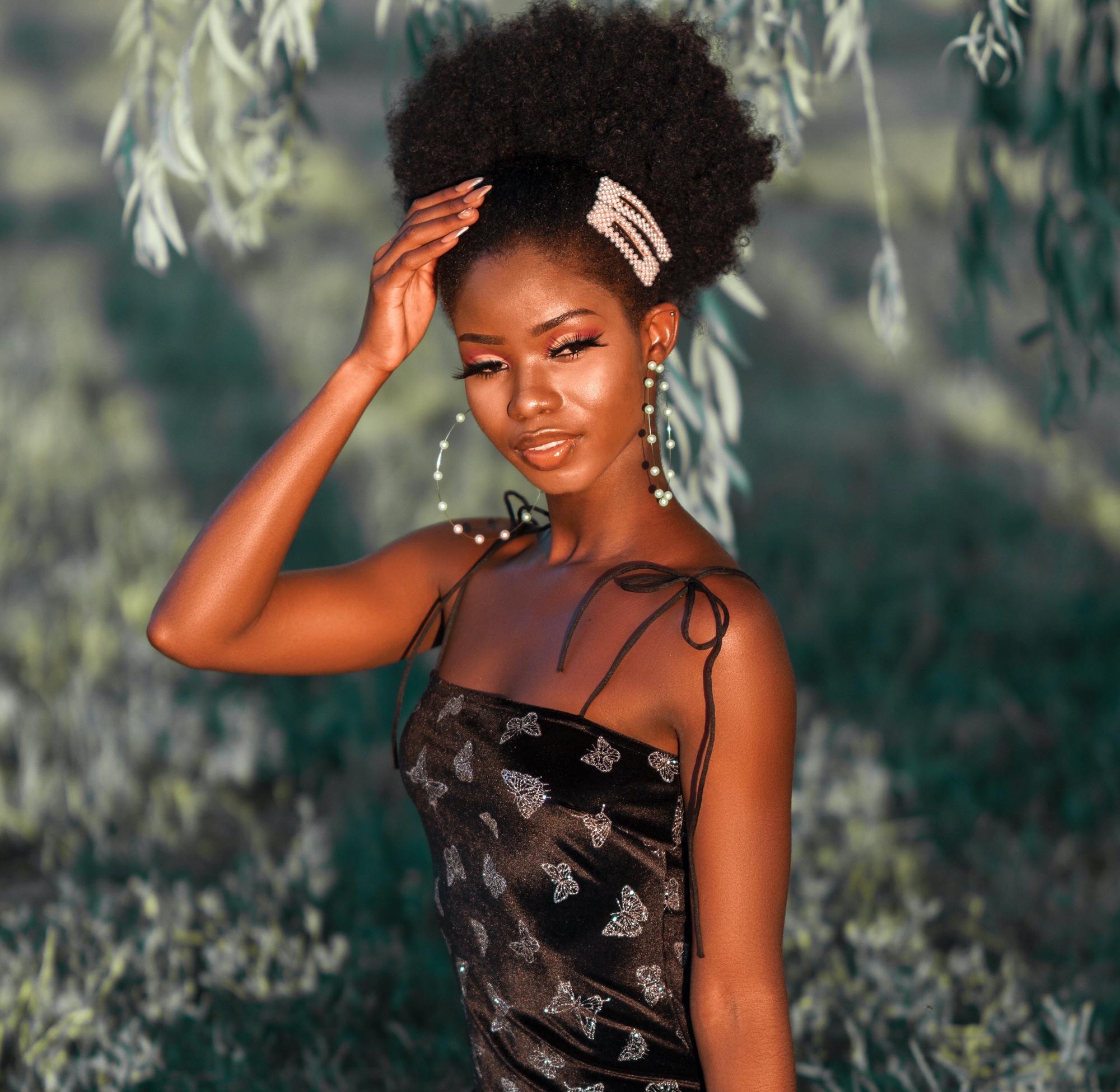woman with natural curls and over the top accessories