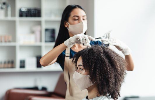 new year's resolutions: woman in a salon getting a her hair trimmed