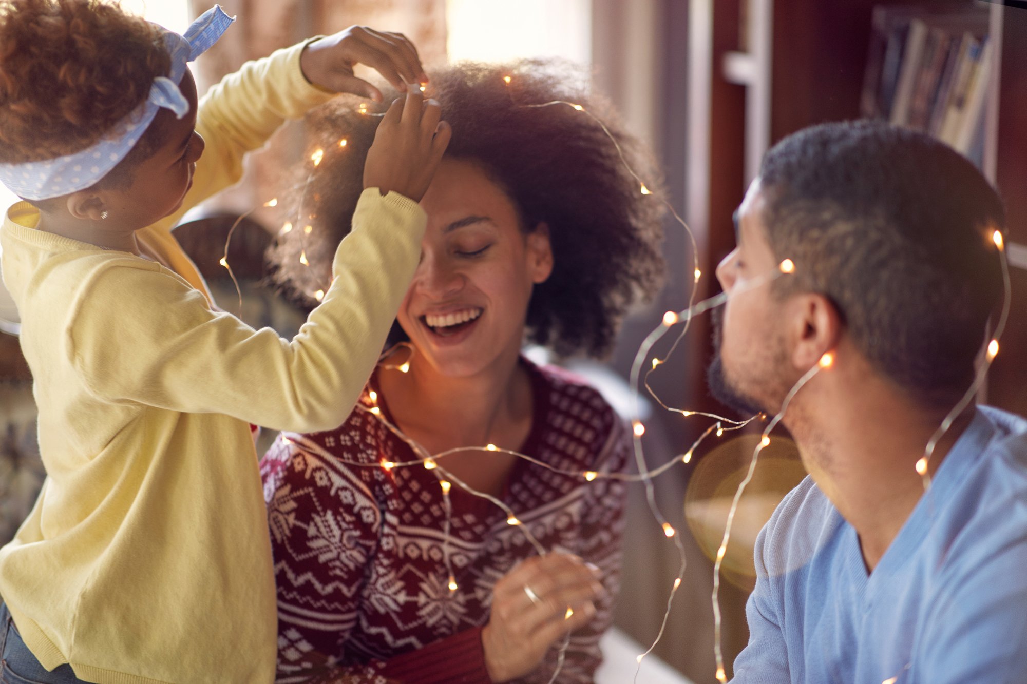 family festive haircare tips: family with festive lights
