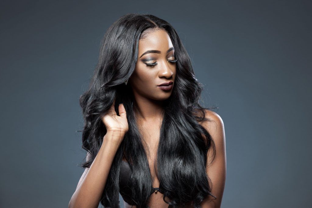 Black woman with long hair with soft bends