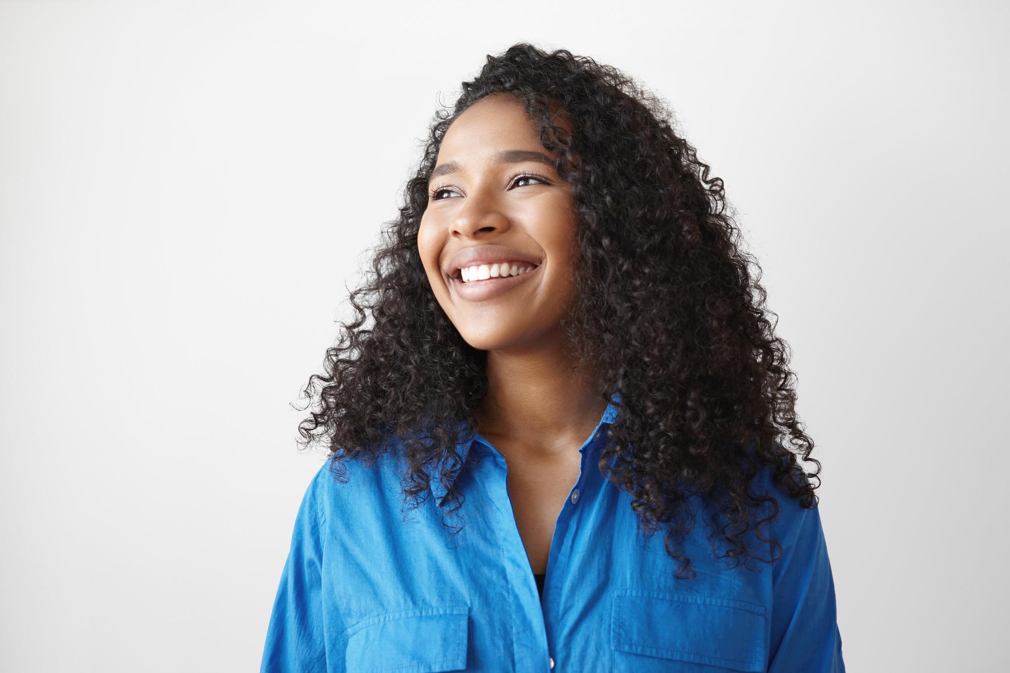 Woman with brown hairdryer diffused natural curls