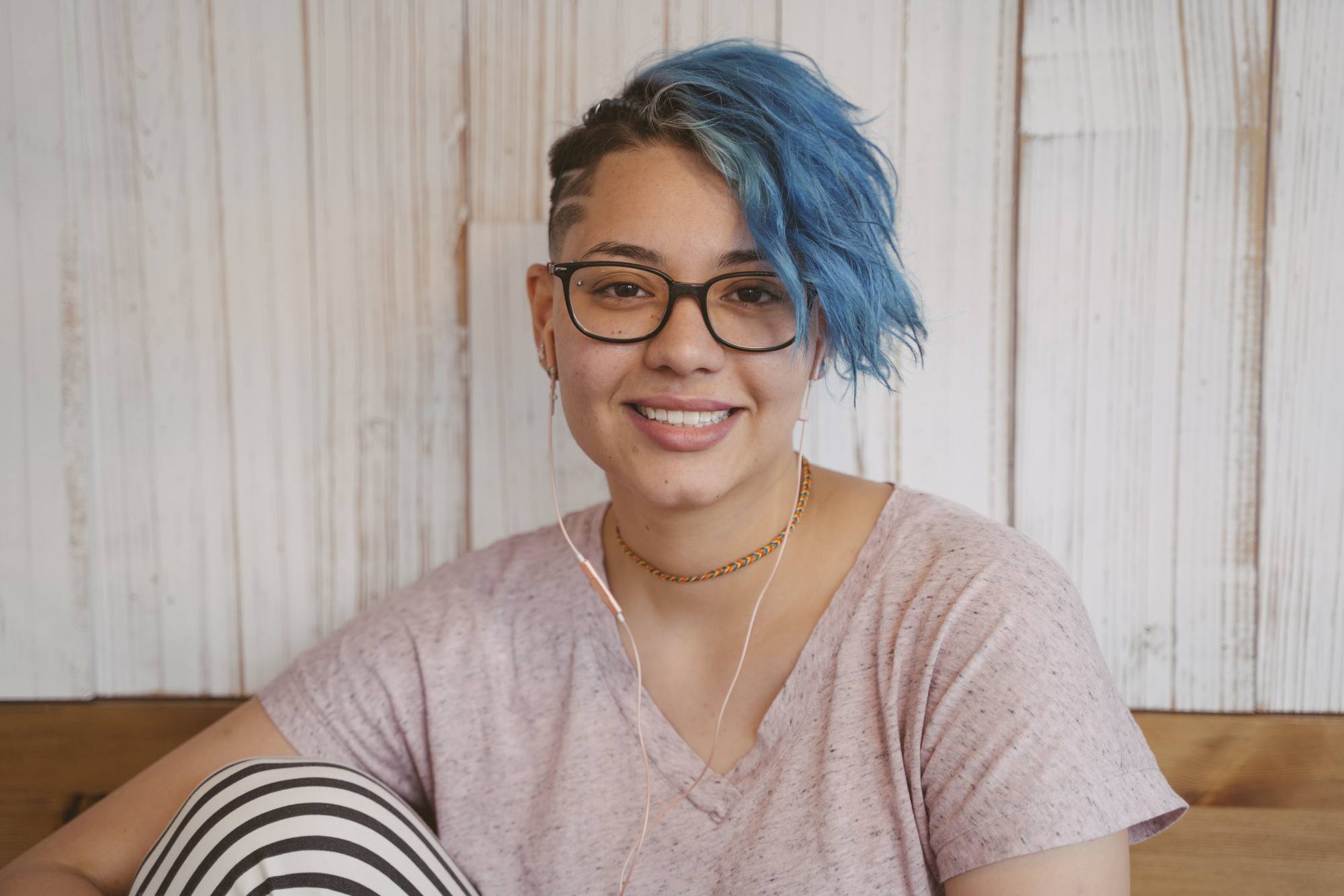 Woman with blue hair and a fluffy pixie cut
