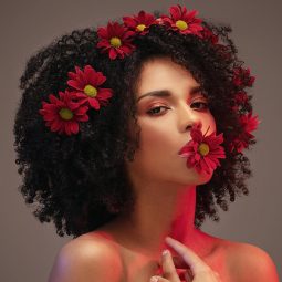 Woman with afro an flowers Valentine's hairstyles