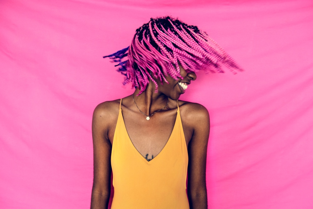 Woman with bright pink braids