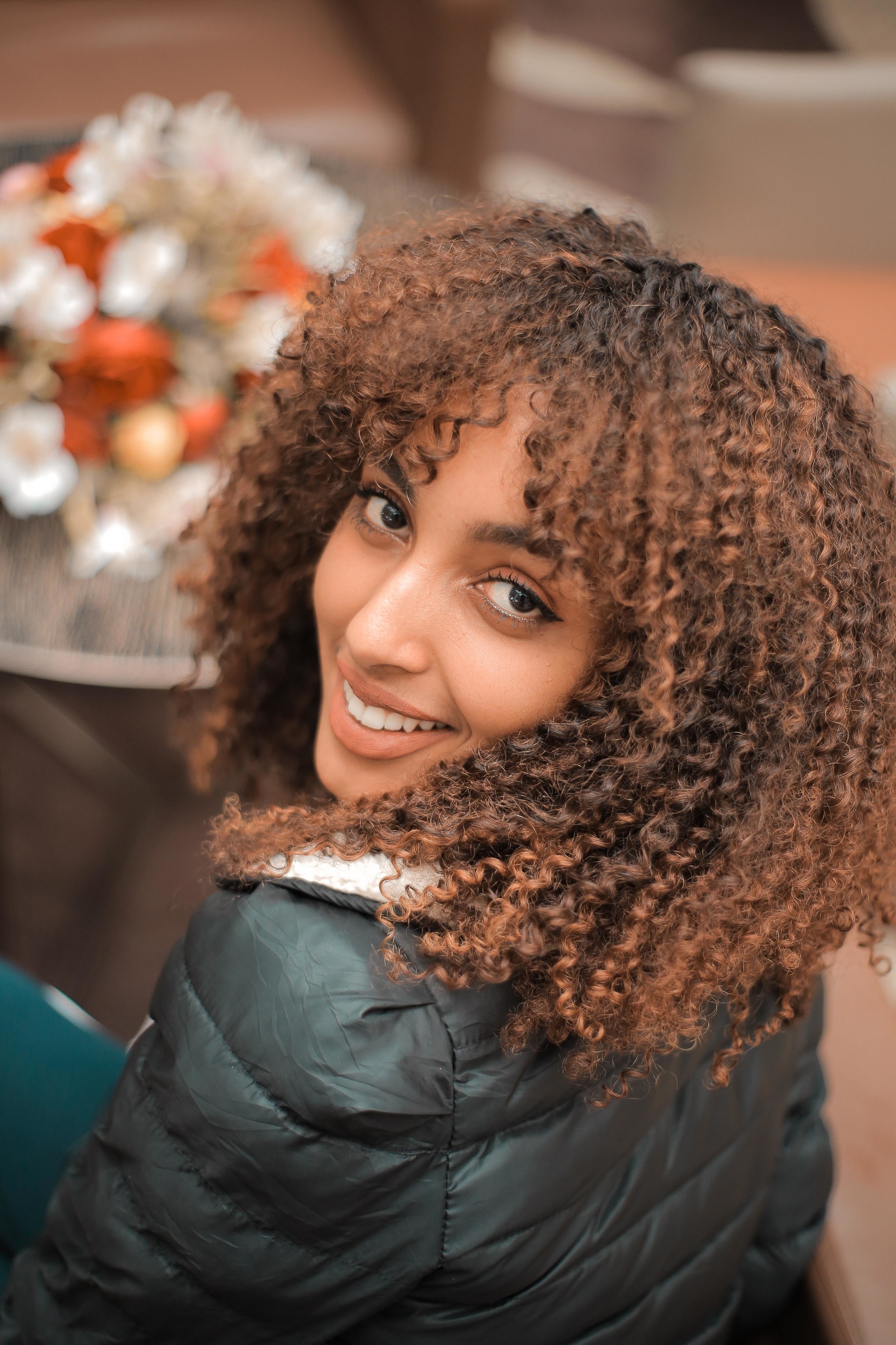 woman with curly shag hairstyle with bangs
