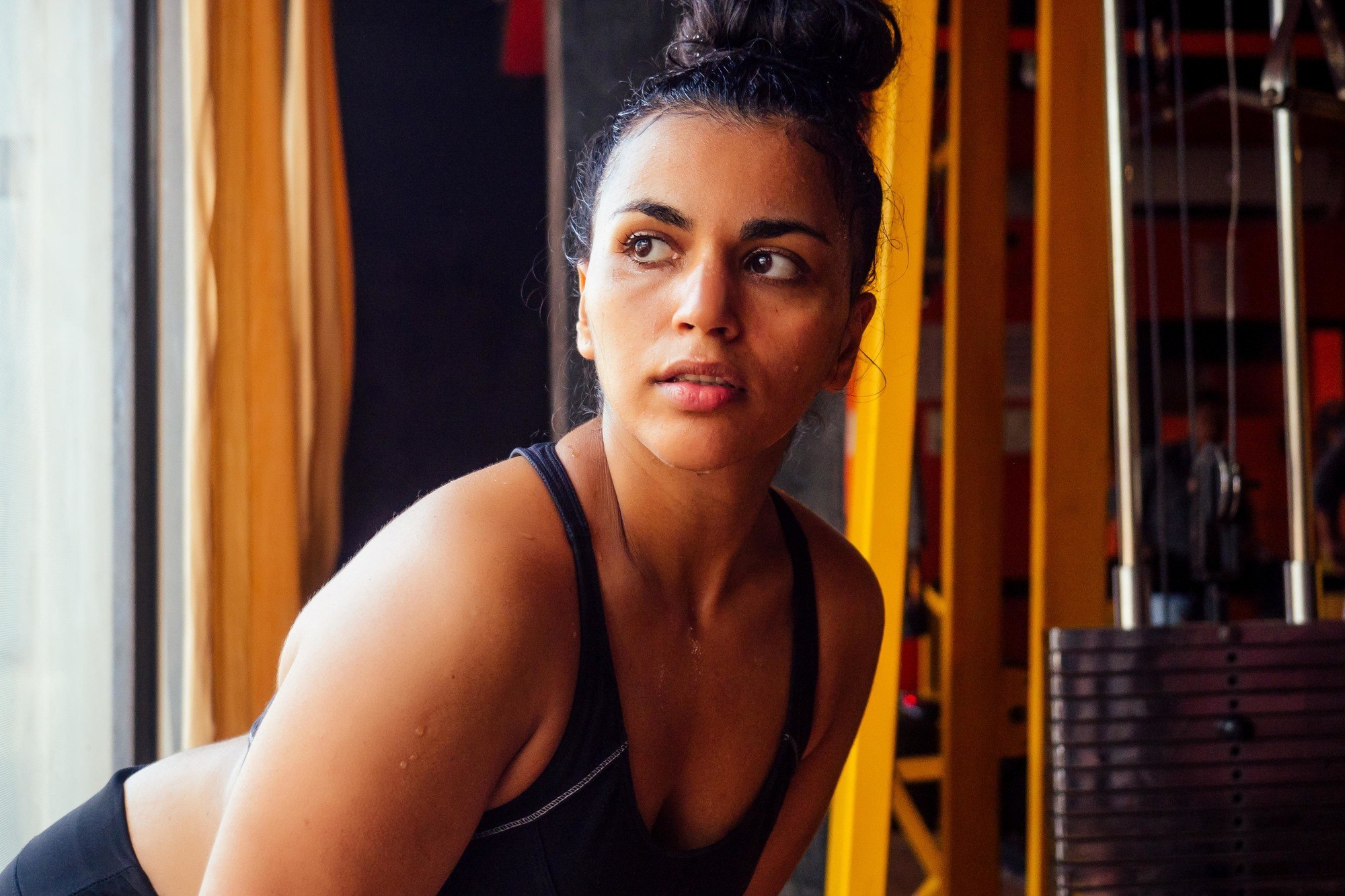 Woman wearing a sleek top knot to workout