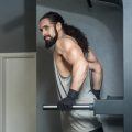 Man with long ponytail working out at gym