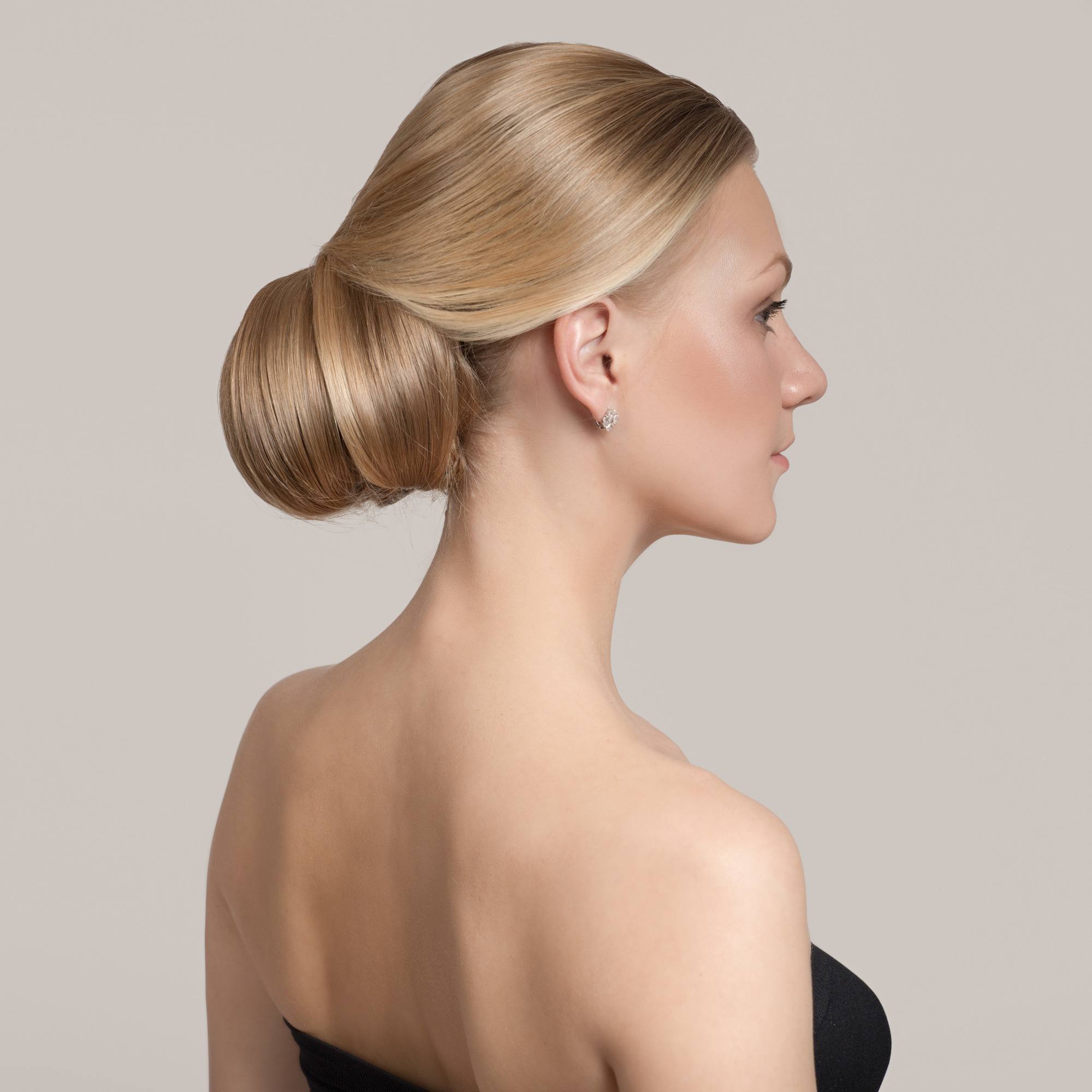 Woman with blonde hair wearing a chignon updo