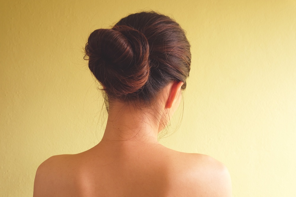 Woman with a sleek low bun hairstyle