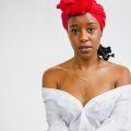 Woman wearing a red headscarf for a kitchen-friendly hairstyle
