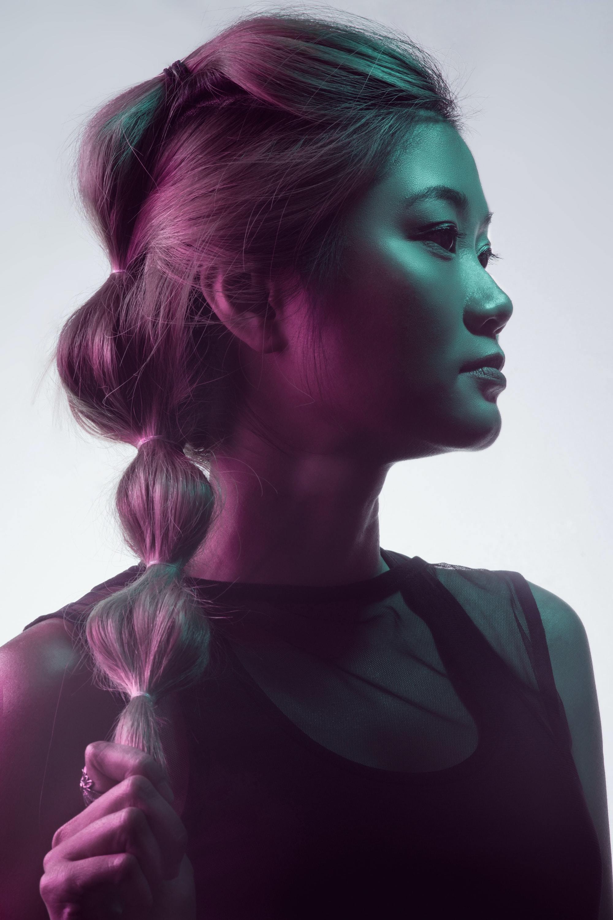 woman with long hair tied in a ponytail with many hair ties