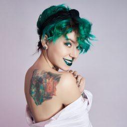 birthstone-inspired hair colour: woman with short green hair