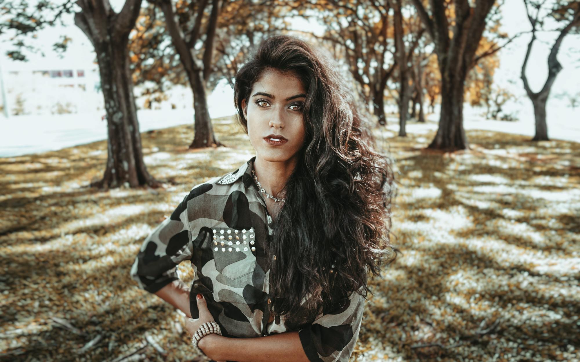 woman with very long, voluminous wavy hair, swept over one shoulder