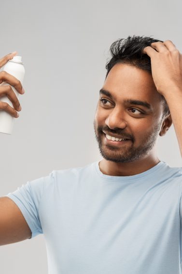man applying product to his hair