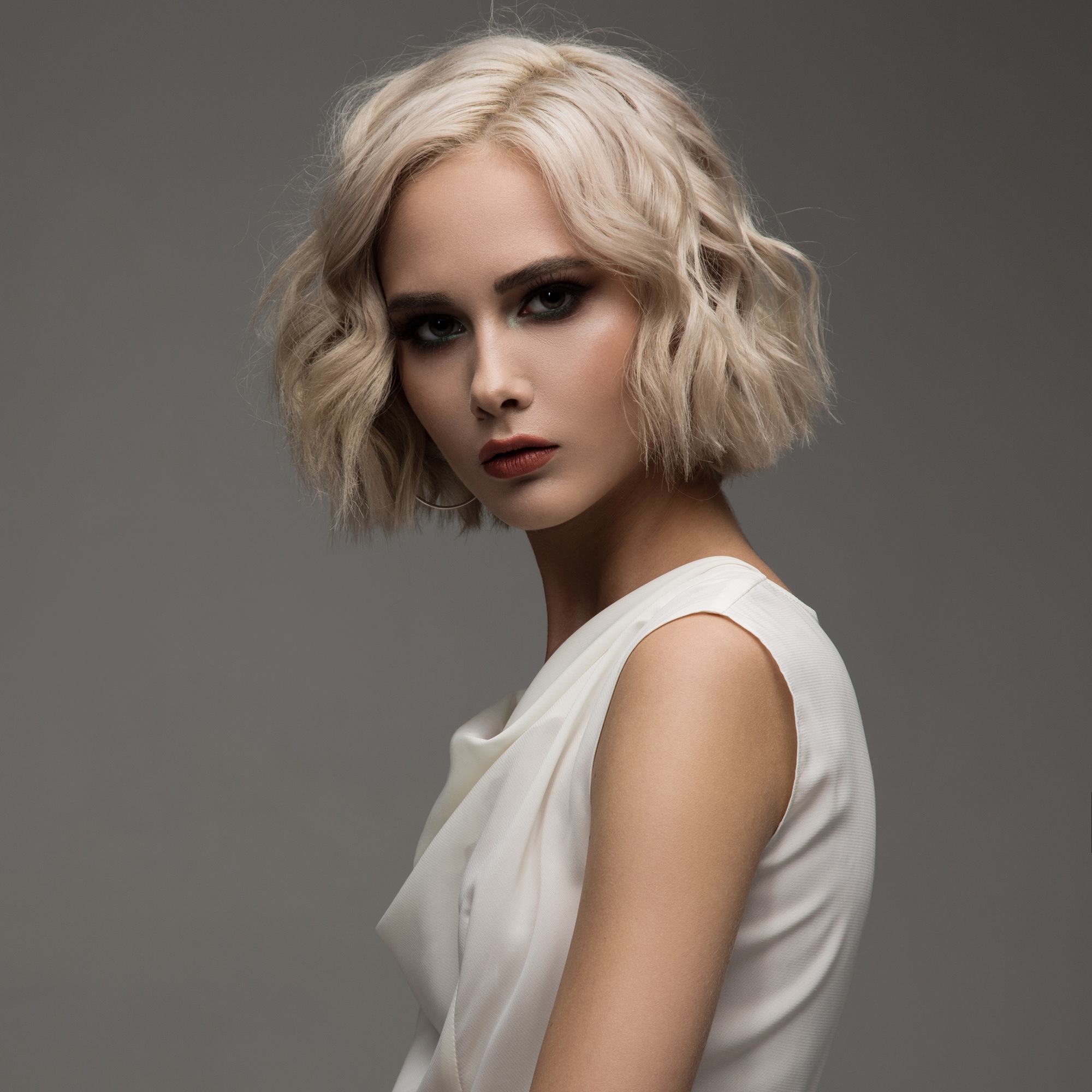woman with a blunt-cut, tousled blonde bob hairstyle