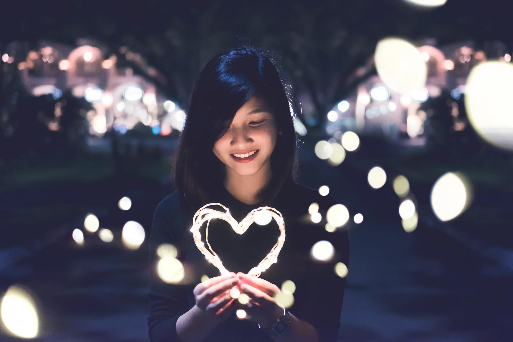 mental health: woman holding a wire frame heart light-shaped